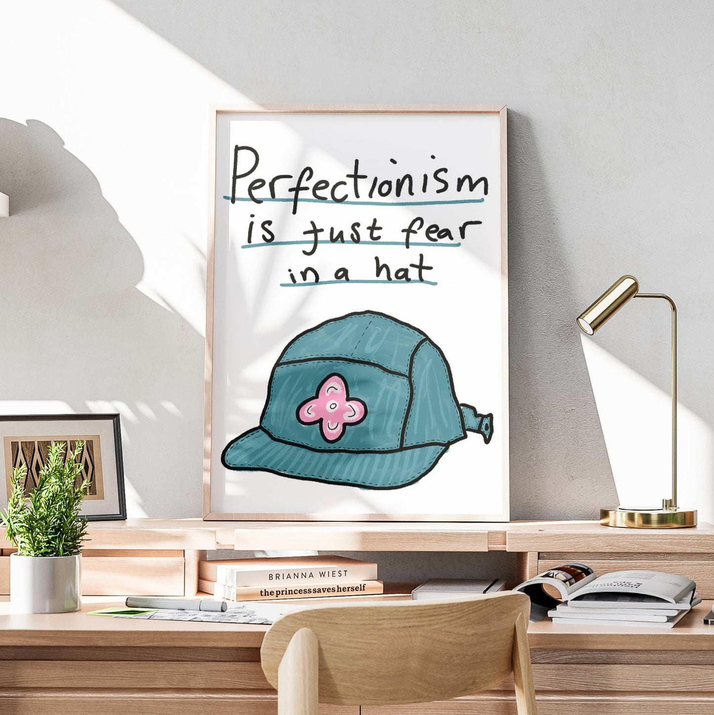 Modern home office with wooden desk, chair, and motivational poster on wall.