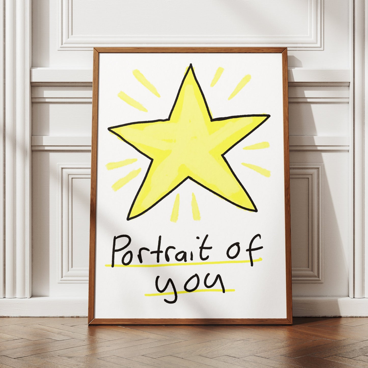 Framed artwork with a yellow star and text 'Portrait of you' on a white wall.